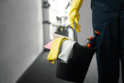 Siivoojan työvälineet ja keltaiset suojakäsineet
